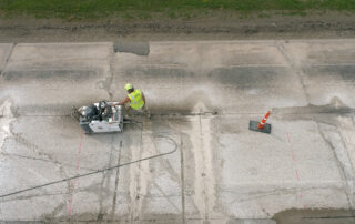 man pushing concrete saw